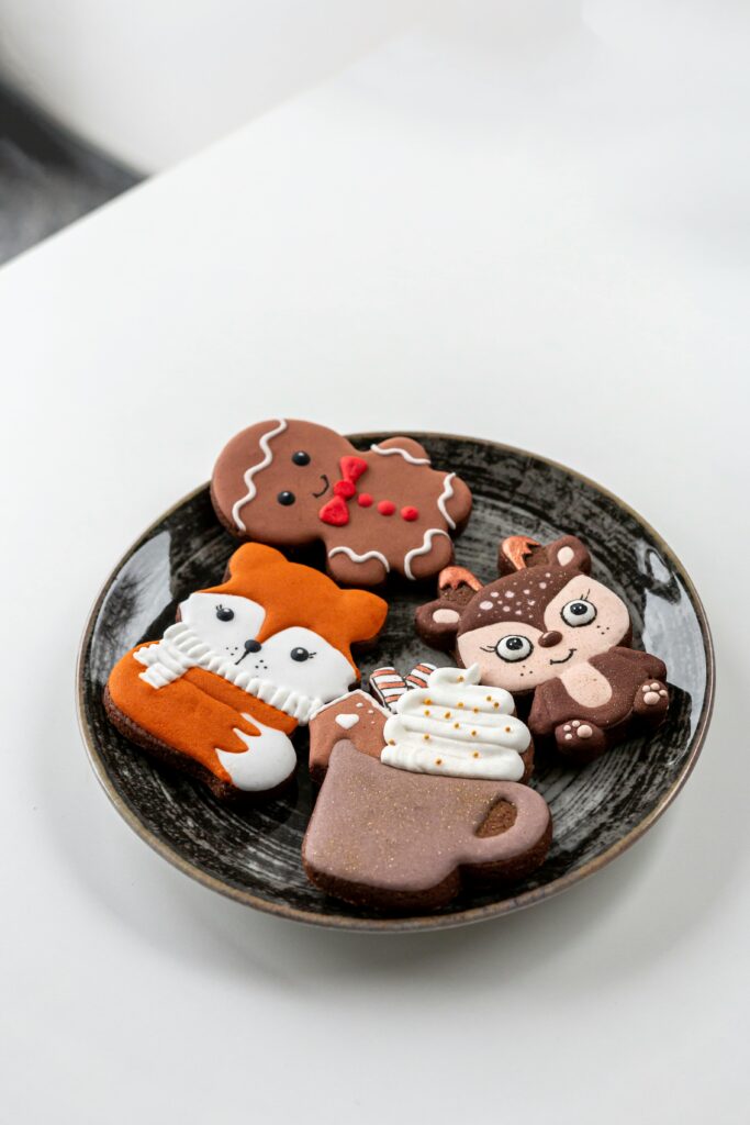 woodland creature royal icing decorated cookies on a black plate